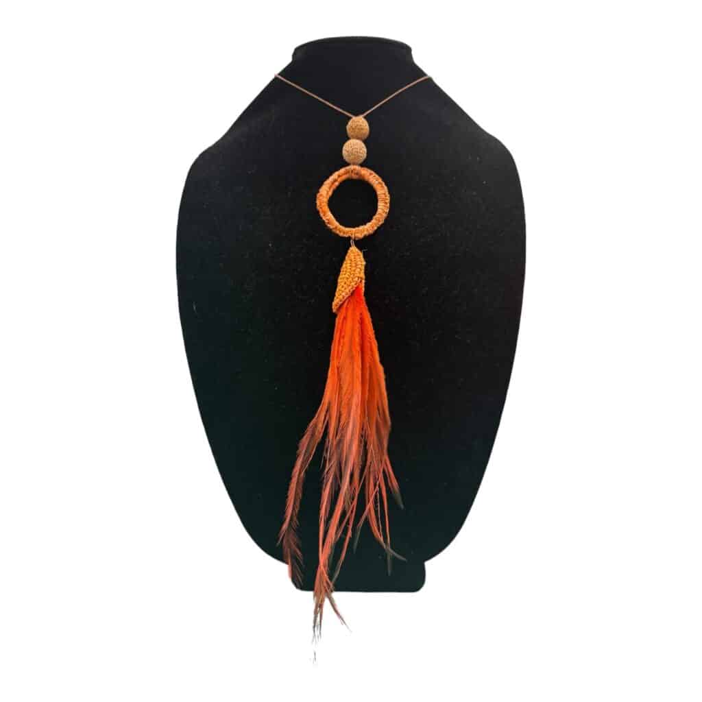 Discover "Ember Circle," a stunning handwoven necklace from Debbie Wood's "The NAIDOC Collection." Featuring raffia, emu feathers, and quandong seeds, this piece celebrates Aboriginal culture and craftsmanship.