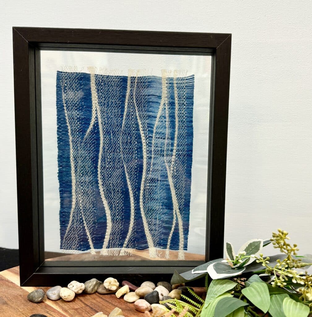 Experience "Outback Streams" by Ashculme Textiles, a beautiful textile art piece crafted from hand-reared alpaca wool and natural dyes, evoking the flowing streams of the Australian outback. Perfect for nature-inspired decor.