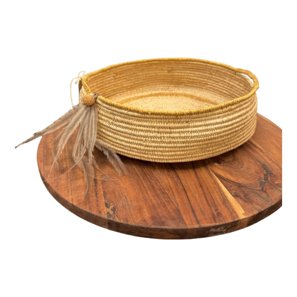 Celebrate cultural heritage with the "Emu Spirit Basket," a traditionally woven basket by Gomeroi artist Debbie Wood. Part of "The NAIDOC Collection," this piece features natural raffia and emu feathers, embodying artistic tradition and natural beauty.