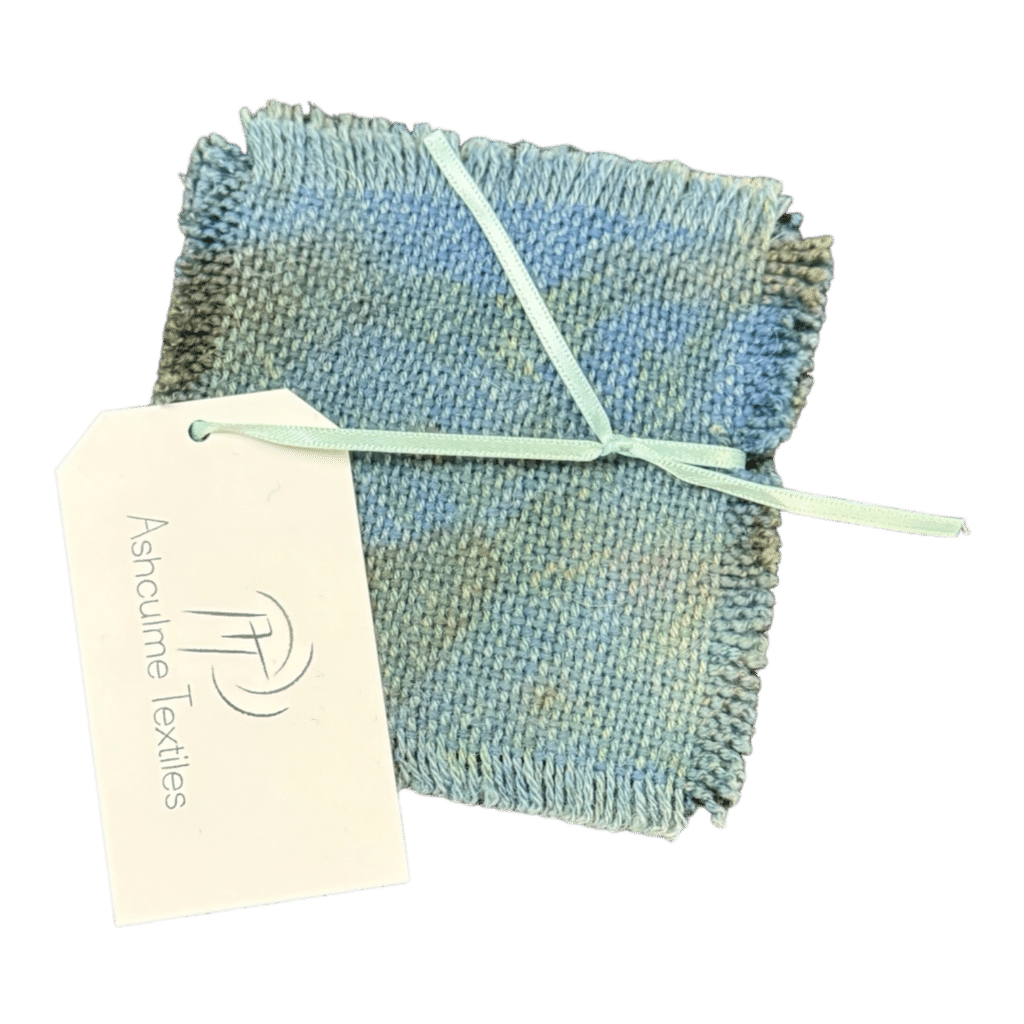 Add a touch of coastal elegance with the Ocean Breeze Coaster, handcrafted from bush-dyed alpaca and silk wool. Each unique piece captures the serene beauty of the sea.