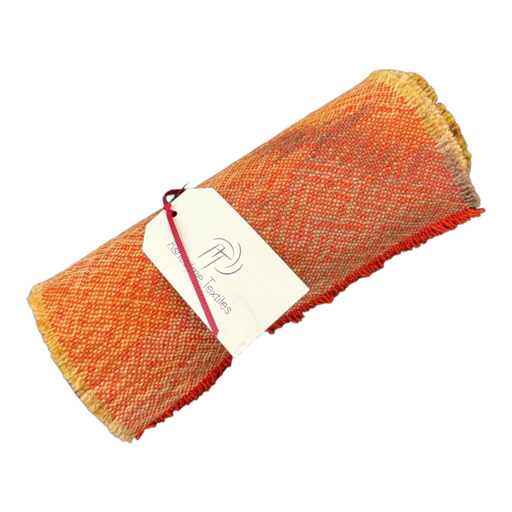 Brighten your dining table with the Fiery Sunset Table Runner, handwoven from alpaca and silk wool and dyed with natural bush dyes. Each piece is a unique, handcrafted work of art.