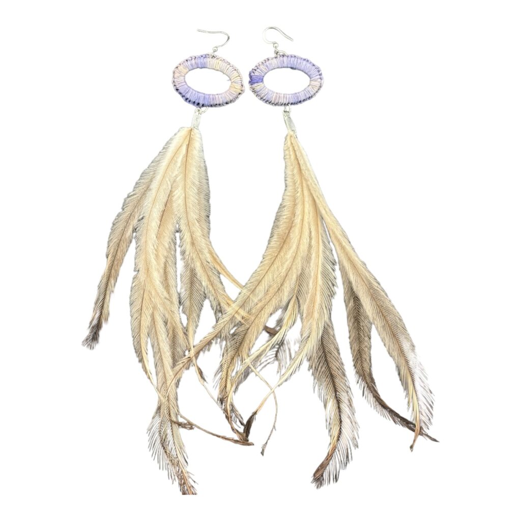 Discover the "Desert Bloom" earrings from the NAIDOC Collection by Gomeroi artist Debbie Wood. Hand-woven with lavender raffia and emu feathers, these earrings celebrate Indigenous artistry.