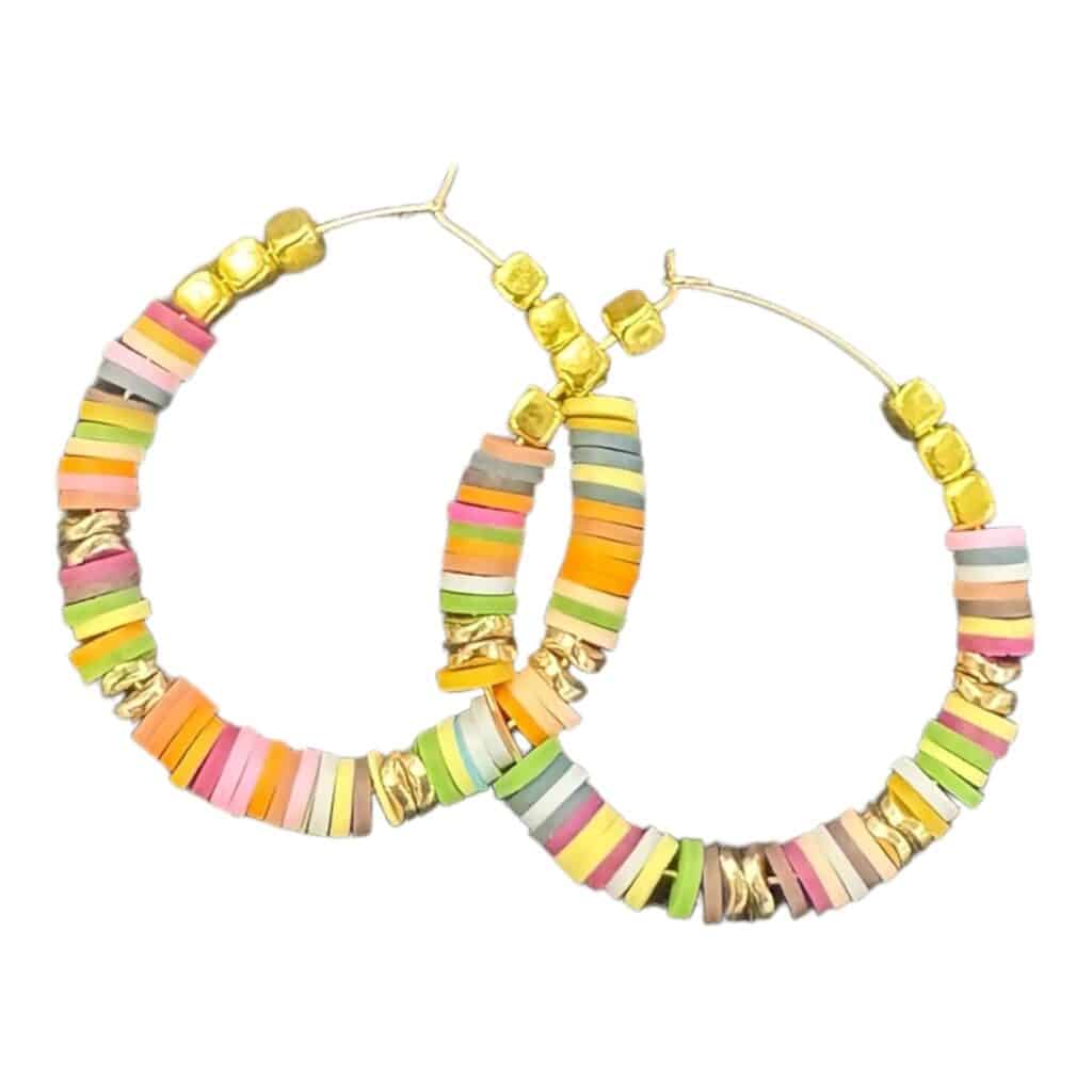 Add a burst of colour with the Sunset Fiesta earrings by Maggie Deall. Features vibrant disc beads and golden accents, perfect for any celebration.