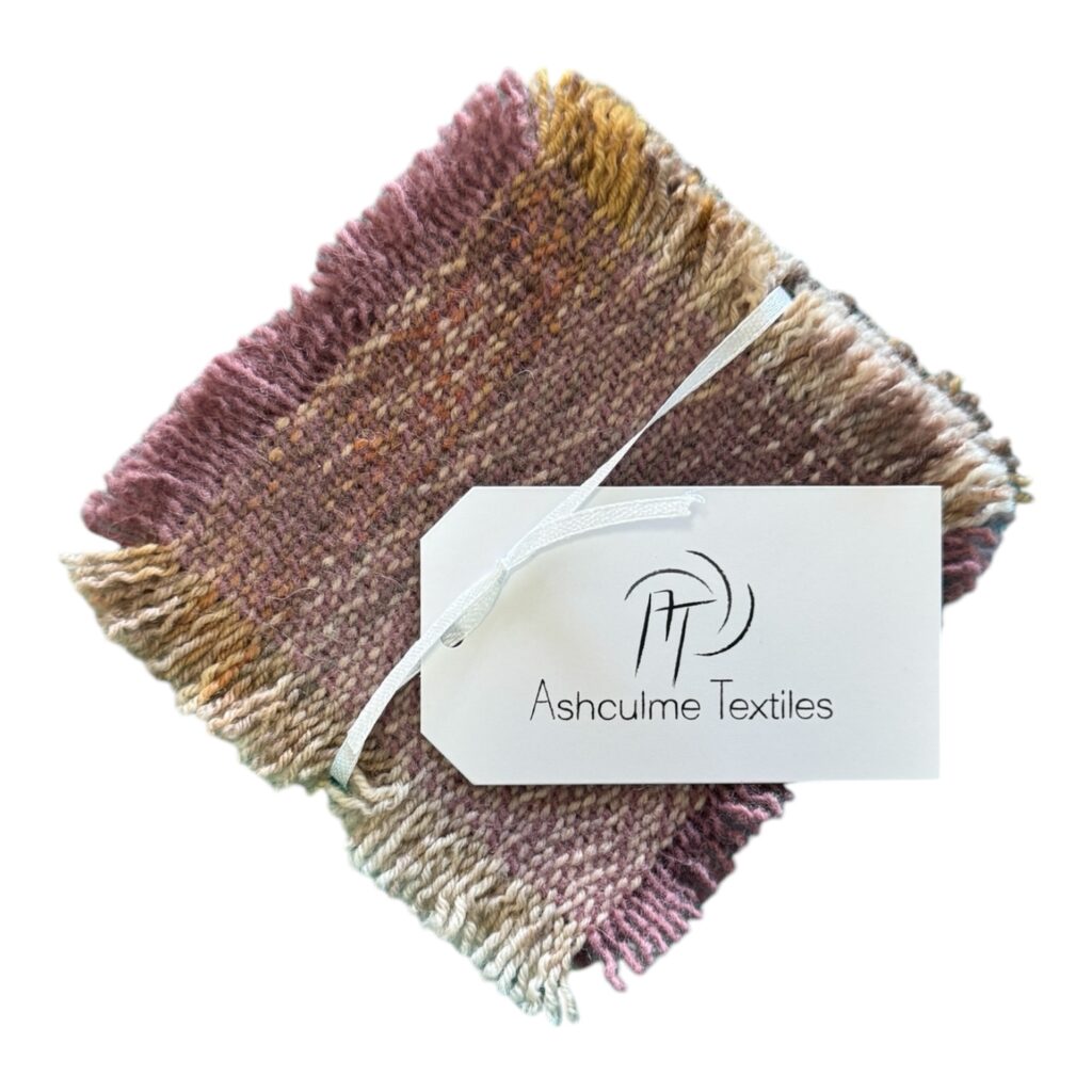 The Autumn Harvest Coaster Set brings the warmth of fall into your home with its handwoven design in soft browns and blush pinks.