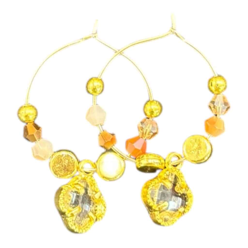 Handcrafted Autumn Sparkle Hoops: Inspired by fall colors with crystals, gold accents, and delicate charms for a seasonal touch.