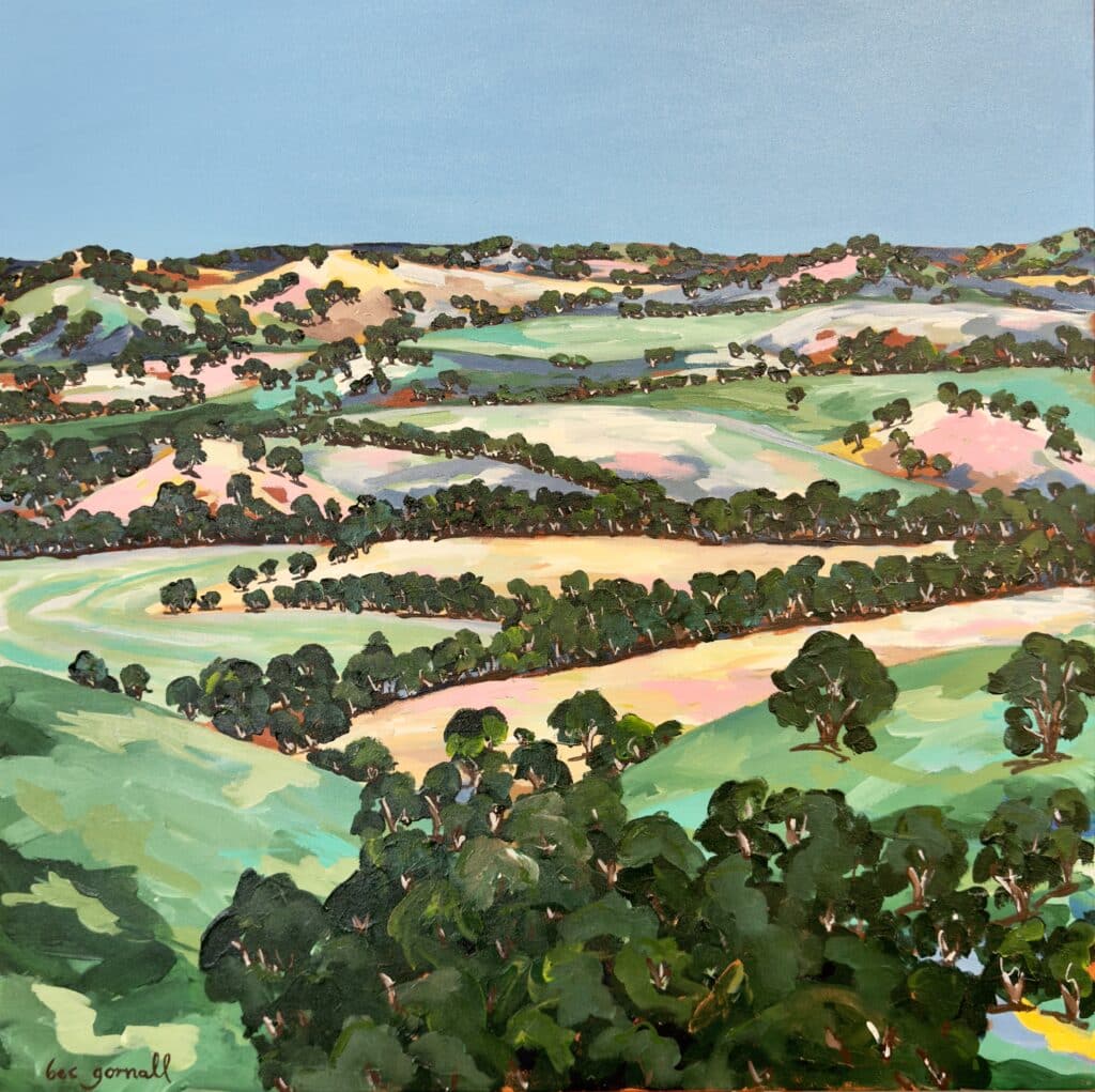 "The Lookout" by Rebecca Gornall offers a sweeping view of rolling Australian hills in rich greens, oranges, and pinks under a bright blue sky.