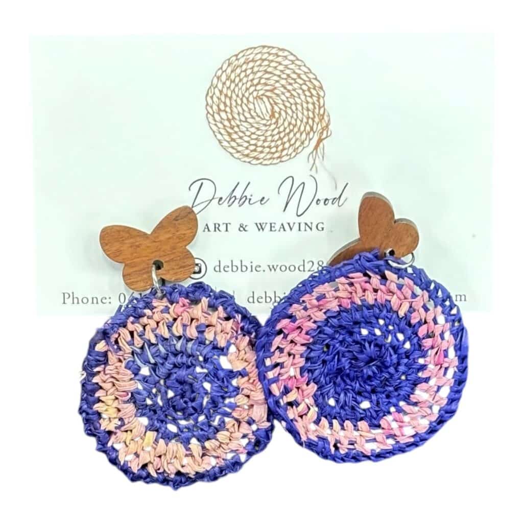 Butterfly Dream handwoven earrings by Gomeroi artist Debbie Wood. Blue and pink raffia with wooden butterfly accents for a whimsical look.