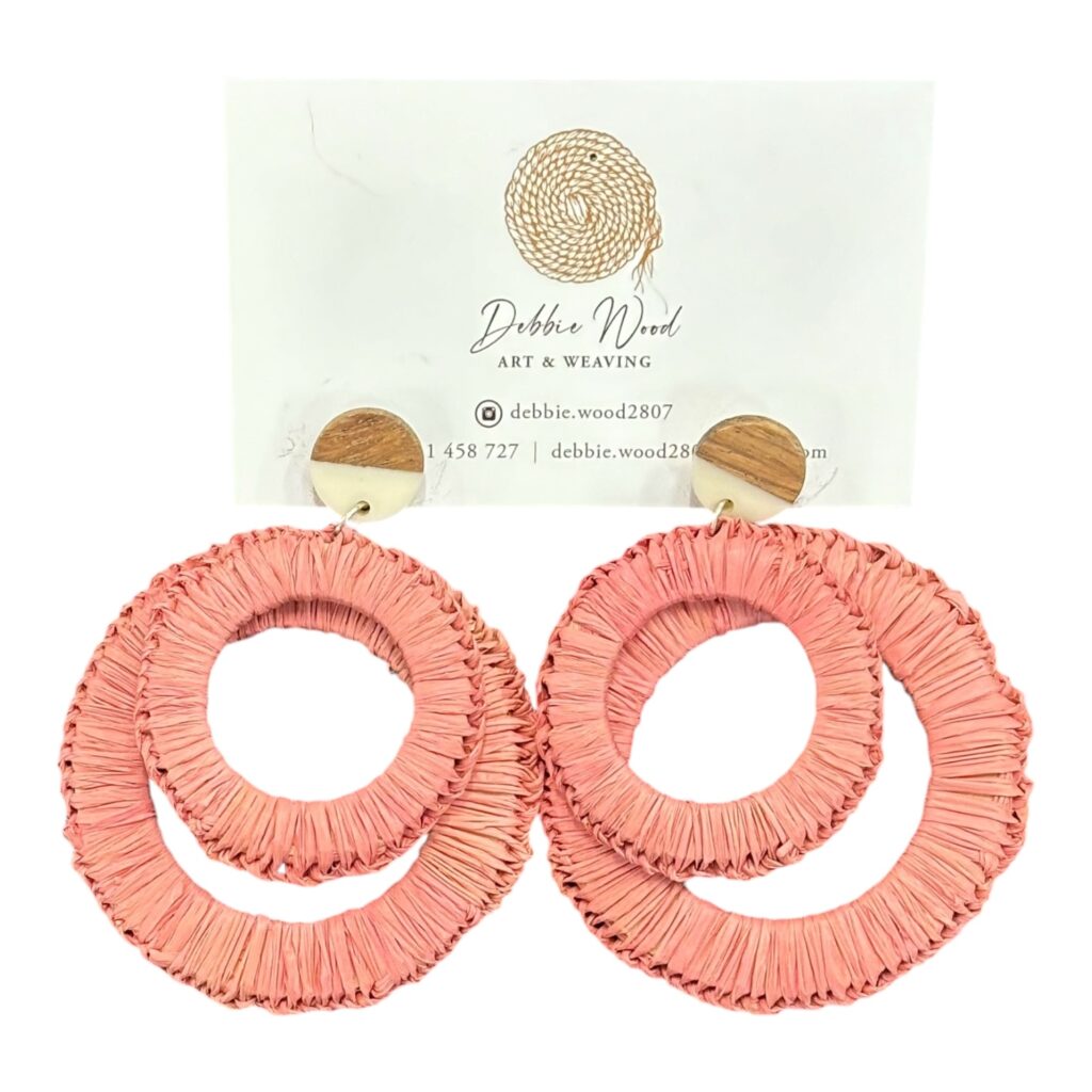 Coral Reef handwoven earrings by Gomeroi artist Debbie Wood. Soft coral-colored raffia in a layered design inspired by coastal beauty.